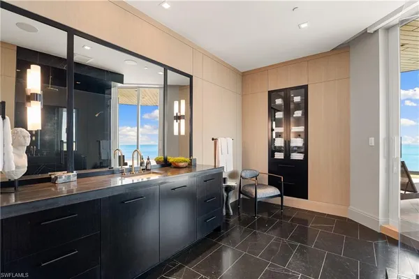 a spacious bathroom with a double vanity sink a mirror and a bathtub
