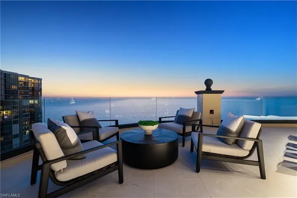 a roof deck with a table and chairs