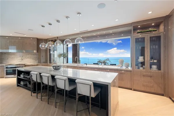 a large kitchen with a table and chairs