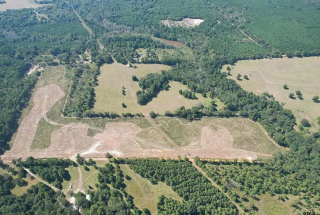 an aerial view of a house with a yard