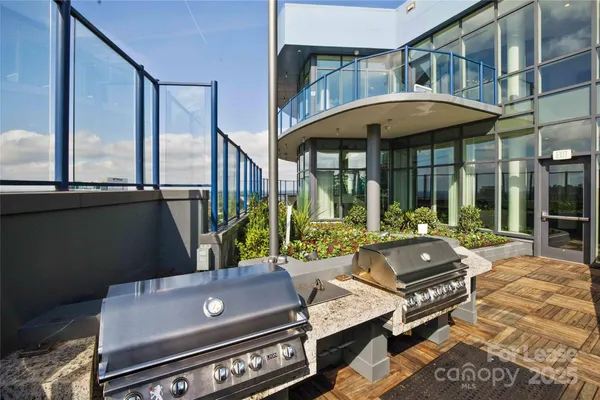 a living room filled with furniture and large windows