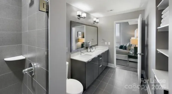 a bathroom with a sink vanity mirror and toilet