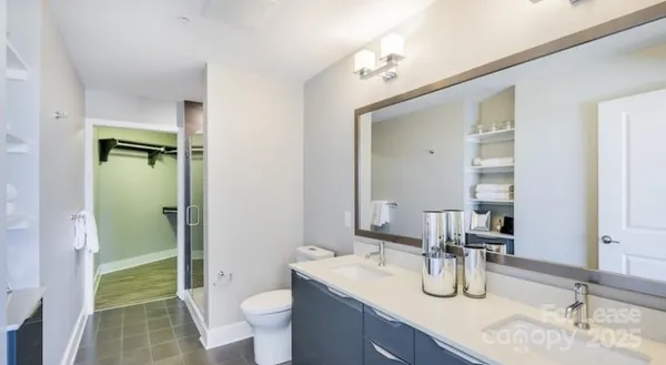 a bathroom with a granite countertop sink toilet and shower