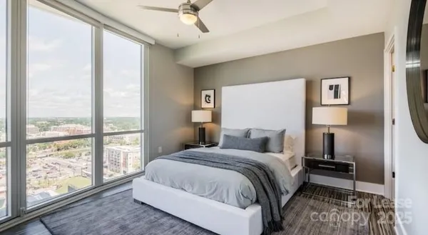 a bedroom with a large bed and a large window