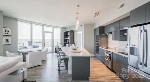 a large kitchen with a large window and stainless steel appliances