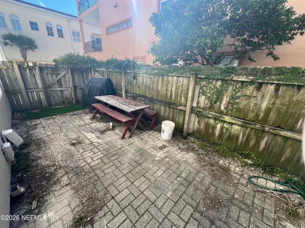 a backyard of a house with table and chairs