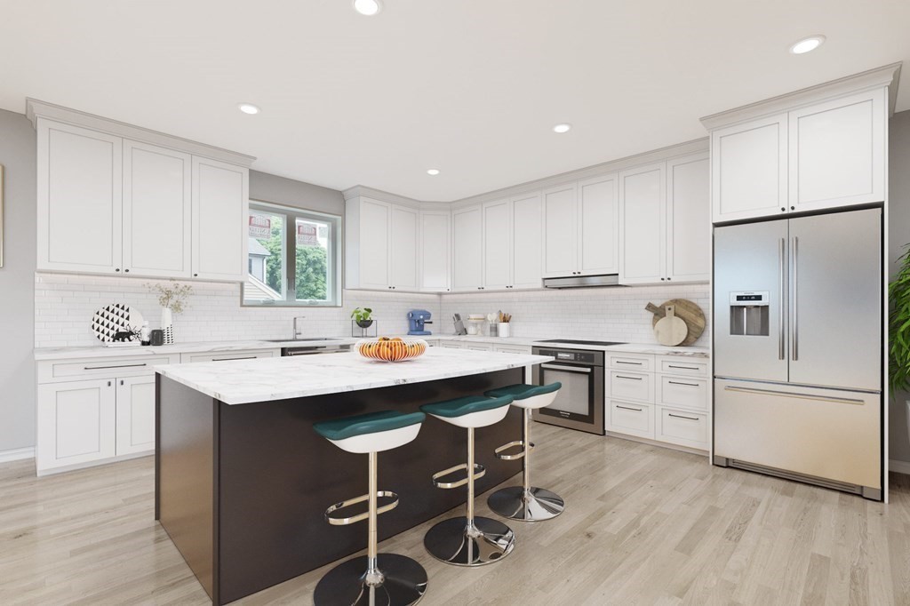 32 Gale Street, Unit 1 Waltham, MA 02453 - Photo 2 of 8 a kitchen with white cabinets and white appliances