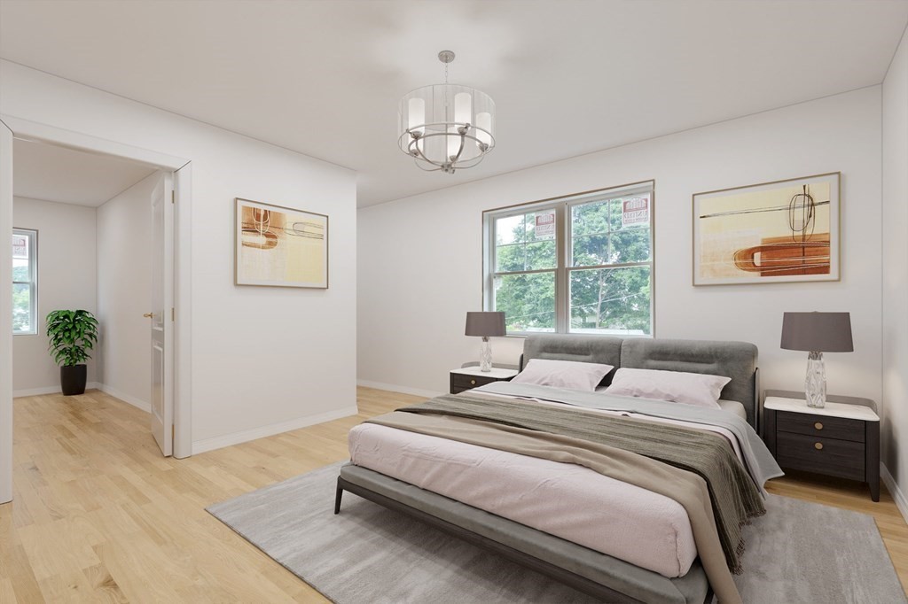 32 Gale Street, Unit 1 Waltham, MA 02453 - Photo 4 of 8 a bedroom with a bed and a chandelier