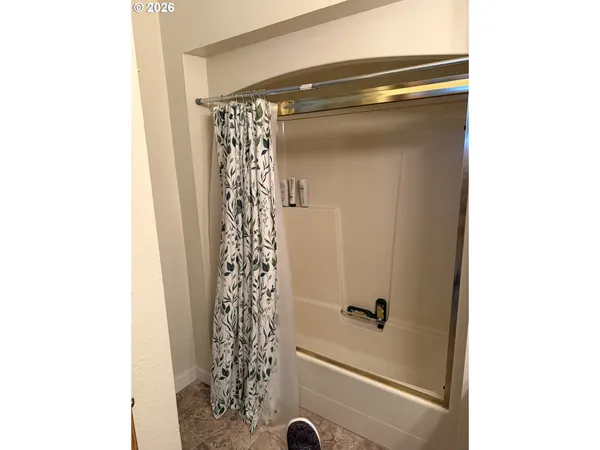 a bathroom with a shower and a tub