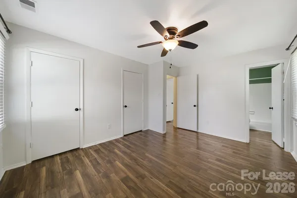 a view of a livingroom with wooden floor and a ceiling fan