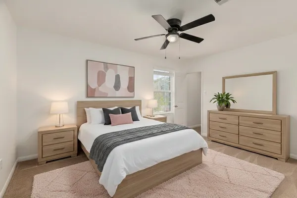 a bedroom with a bed chandelier dresser and a window