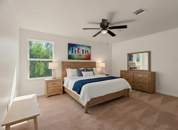 a bedroom with a bed and a window