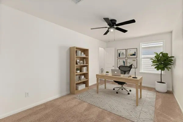 a work room with furniture and a potted plant