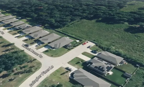 an aerial view of a house with a yard