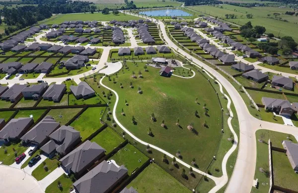 an aerial view of a residential houses with outdoor space