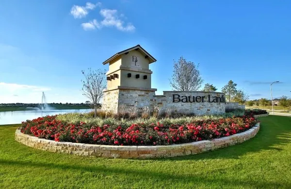 a view of a house with a yard and potted plants