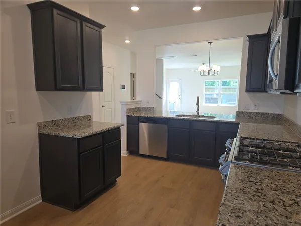 a kitchen with a sink stove and cabinets