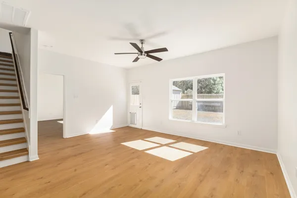 wooden floor in an empty room with a window