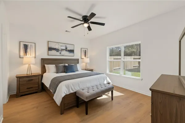 a spacious bedroom with a bed and a window