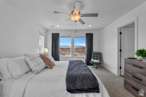 907 West Bright Ridge Ln Street, Unit 1430 St. George, UT 84790 - Photo 16 of 19 Spacious bedroom featuring light neutral wall paint, recessed lighting, a ceiling fan fixture, and two large windows with dark drapery