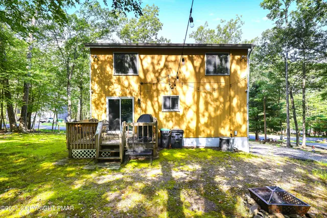 a view of swimming pool with outdoor seating and plants