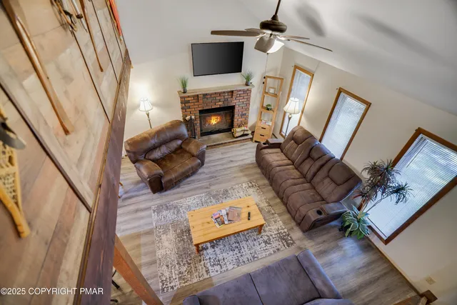 a living room with furniture and a fireplace