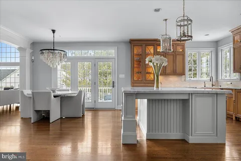 a view of a kitchen with granite countertop a window and a view of living room