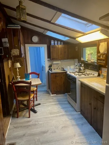 a kitchen with stainless steel appliances granite countertop a sink and wooden cabinets