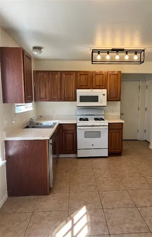 a kitchen with a stove a sink and a microwave