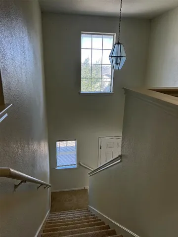 an empty room with a empty space and windows