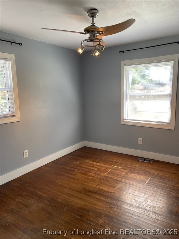 4526 Belford Road Fayetteville, NC 28314 - Photo 13 of 30 an empty room with wooden floor fan and windows