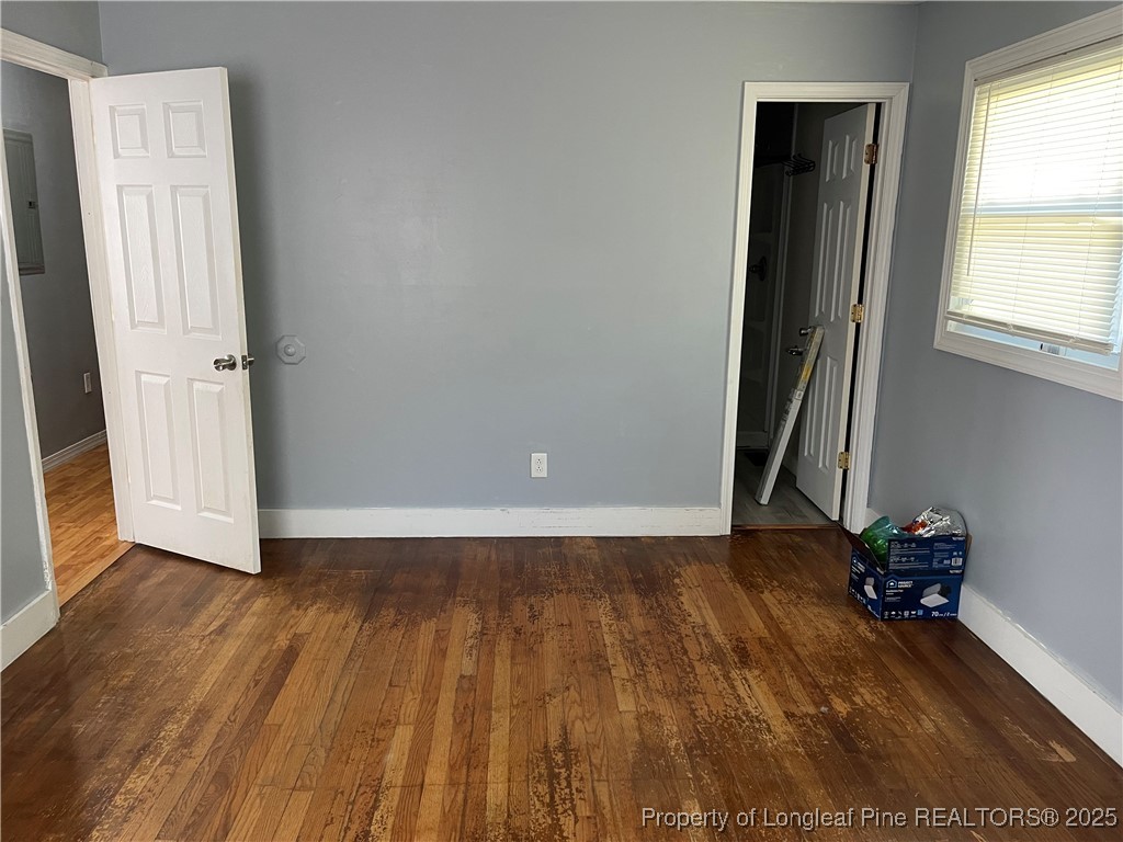4526 Belford Road Fayetteville, NC 28314 - Photo 19 of 30 an empty room with wooden floor and windows