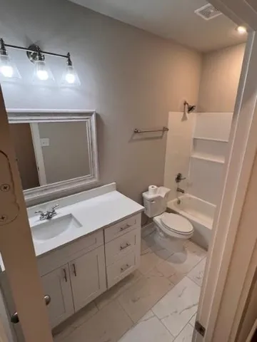 a bathroom with a sink a toilet and mirror