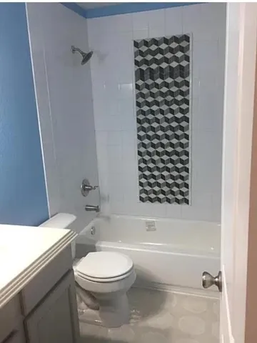 a bathroom with a toilet a sink and a bathtub