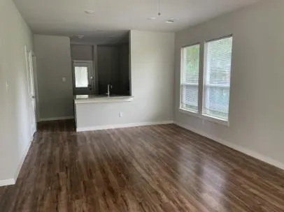 wooden floor in an empty room with a window