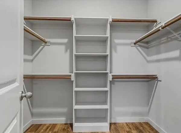 a view of walk in closet with empty racks