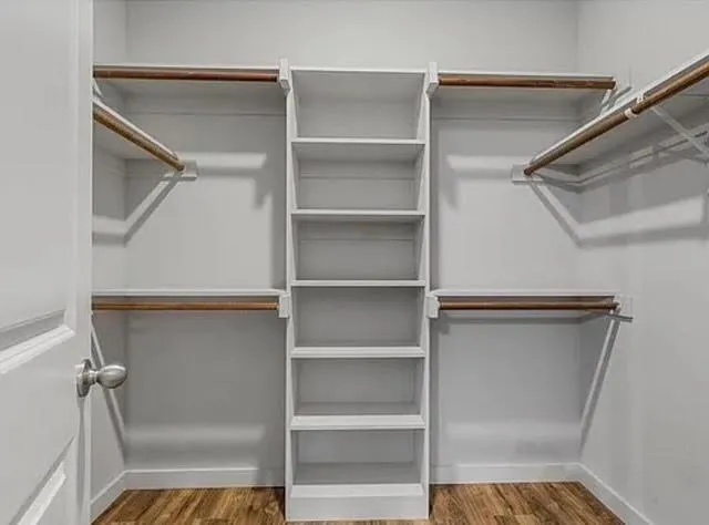 a view of walk in closet with empty racks