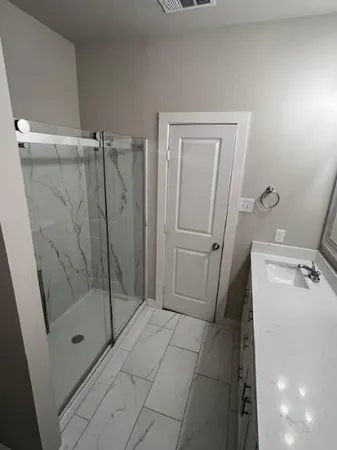 a bathroom with a shower and toilet