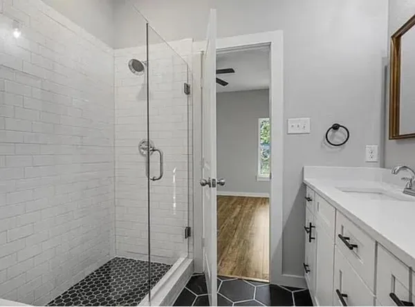 a bathroom with a sink a toilet and shower