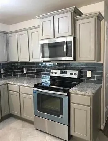 a kitchen with cabinets appliances and a sink