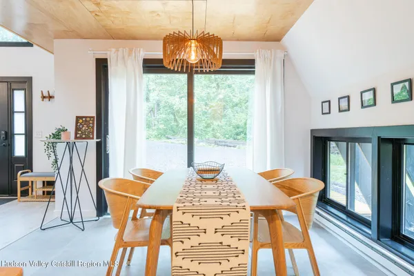 a view of a dining room with furniture window and wooden floor
