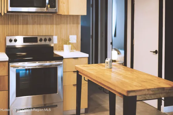 a view of a kitchen with granite countertop a stove and a sink