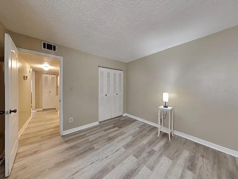 3260 Candle Ridge Drive, Unit 202 Orlando, FL 32822 - Photo 13 of 19 a view of an empty room and wooden floor