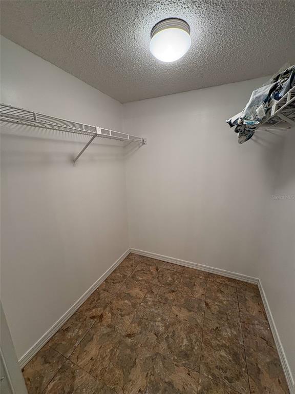 3260 Candle Ridge Drive, Unit 202 Orlando, FL 32822 - Photo 14 of 19 a view of a room with racks on the wall