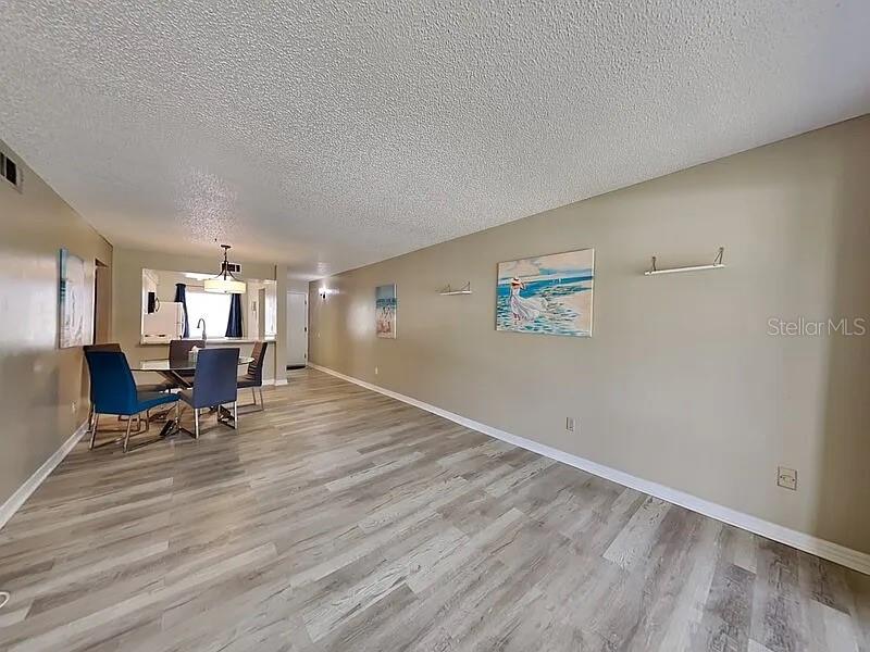 3260 Candle Ridge Drive, Unit 202 Orlando, FL 32822 - Photo 6 of 19 a living room with hardwood wall and a table