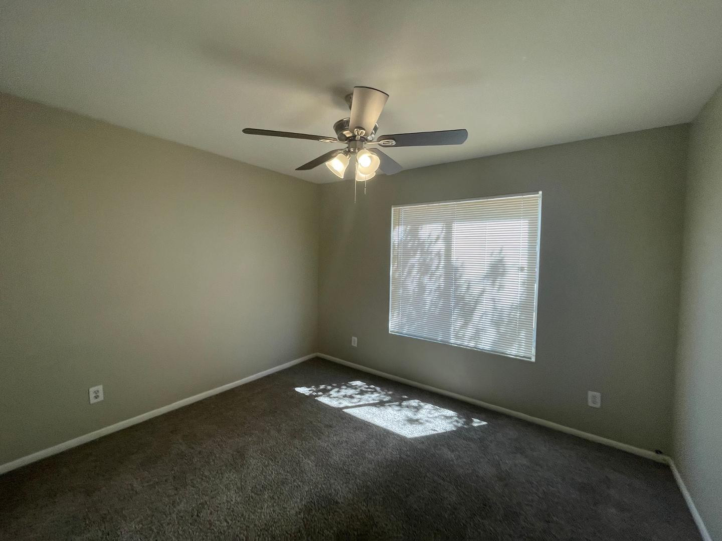 10902 West Montecito Avenue Phoenix, AZ 85037 - Photo 15 of 22 en empty room with windows and fan