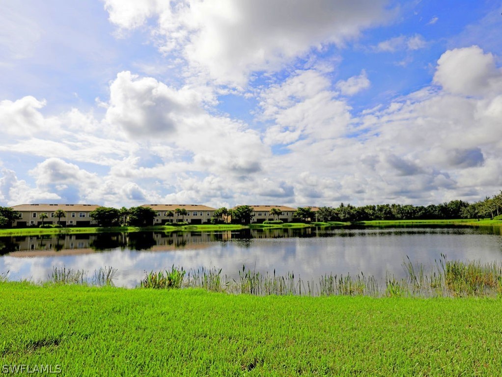 a view of a lake with houses in the back