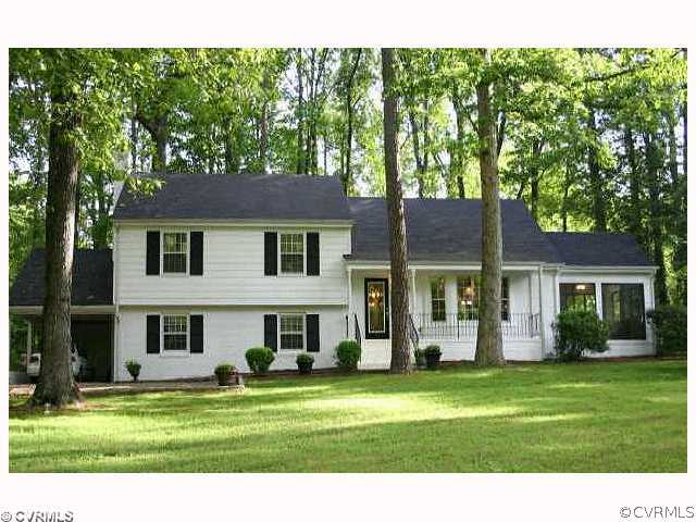8026 Cherokee Road Richmond, VA 23225 - Photo 1 of 12 a front view of a house with a garden