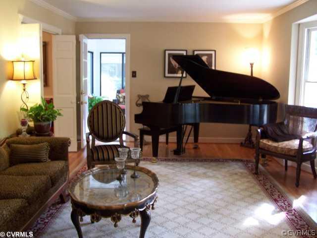 8026 Cherokee Road Richmond, VA 23225 - Photo 2 of 12 a living room with furniture a rug and a chandelier