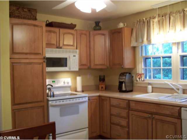 8026 Cherokee Road Richmond, VA 23225 - Photo 3 of 12 a kitchen with stainless steel appliances granite countertop a refrigerator sink and cabinets